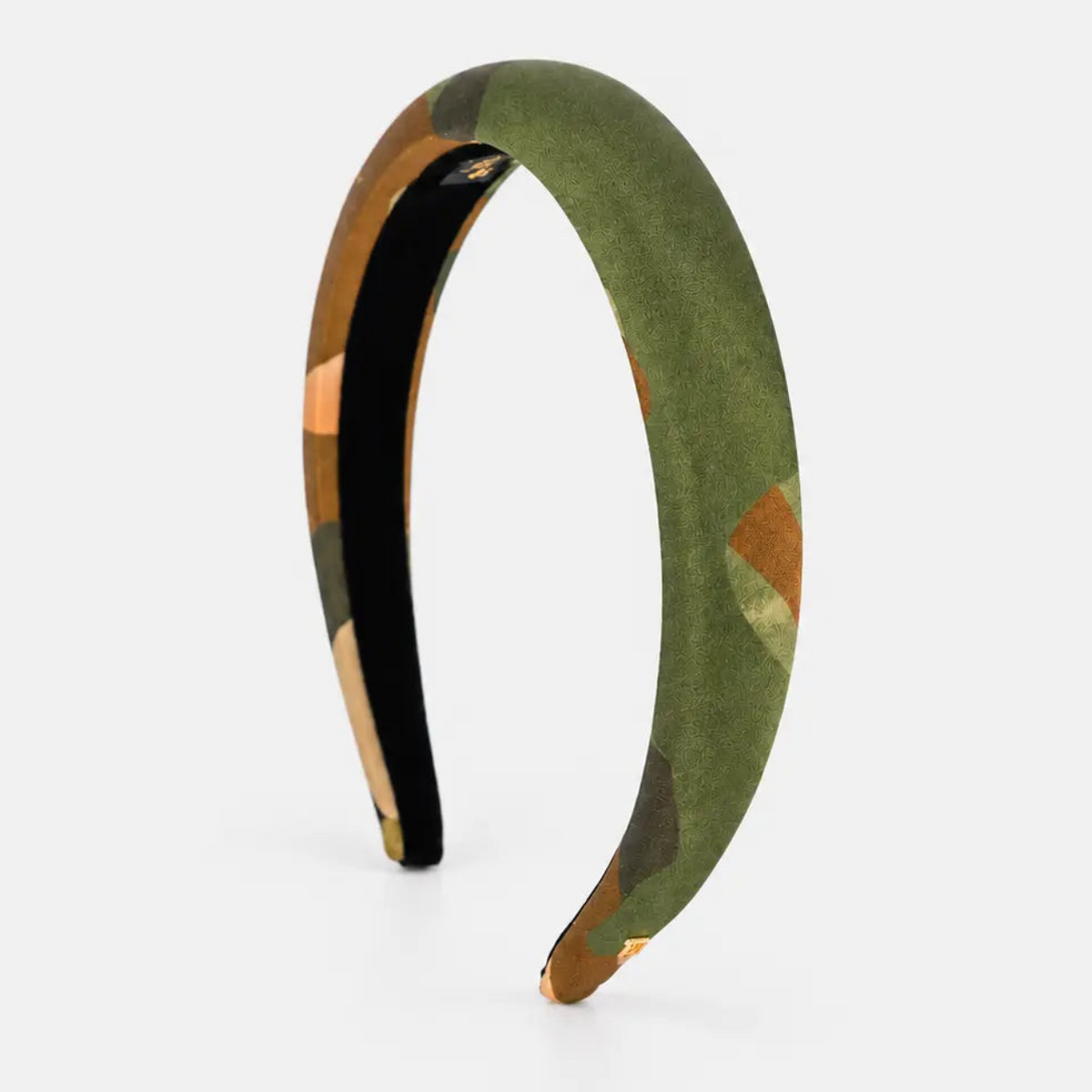 A padded headband in a green camouflage pattern with a black inner lining, displayed on a clean light gray background.